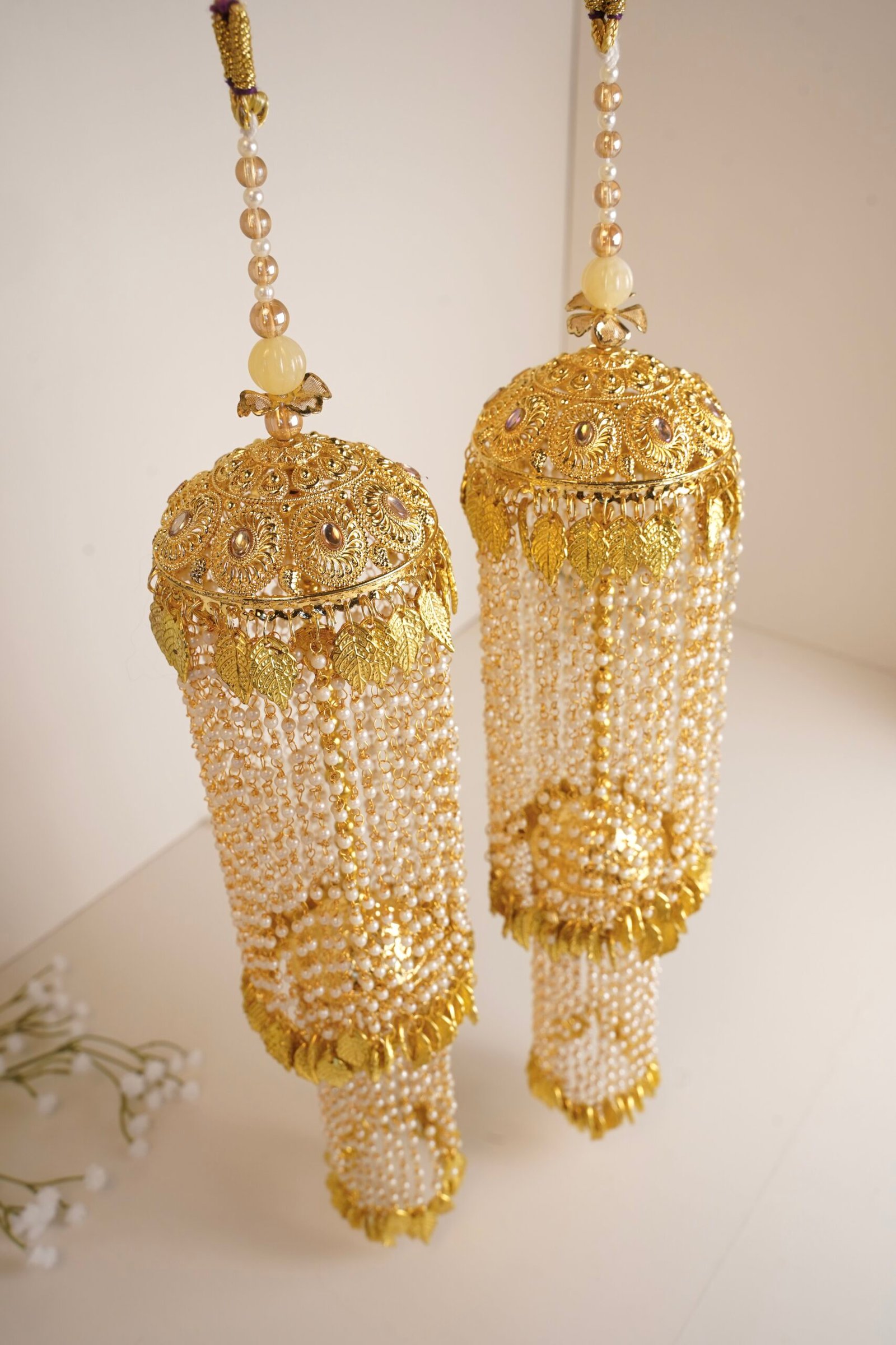 Traditional golden bridal kaleerey with pearls and leaf motifs