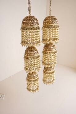 Contemporary bridal wrist jewelry with triple jhumki design