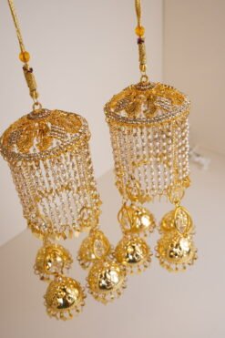 Close-up of bridal kaleerey with dangling gold jhumkas
