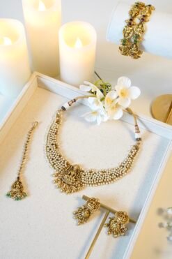 Detailed view of ethnic temple necklace showcasing intricate pearl clusters