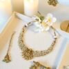 Detailed view of ethnic temple necklace showcasing intricate pearl clusters