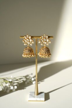 Small delicate floral kundan gold necklace set with jhumka earrings and matching tikka in traditional Indian design