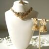 Small delicate floral kundan gold necklace set with jhumka earrings and matching tikka in traditional Indian design