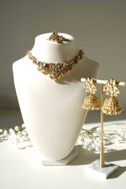 Small delicate floral kundan gold necklace set with jhumka earrings and matching tikka in traditional Indian design