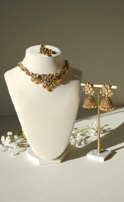 Small delicate floral kundan gold necklace set with jhumka earrings and matching tikka in traditional Indian design