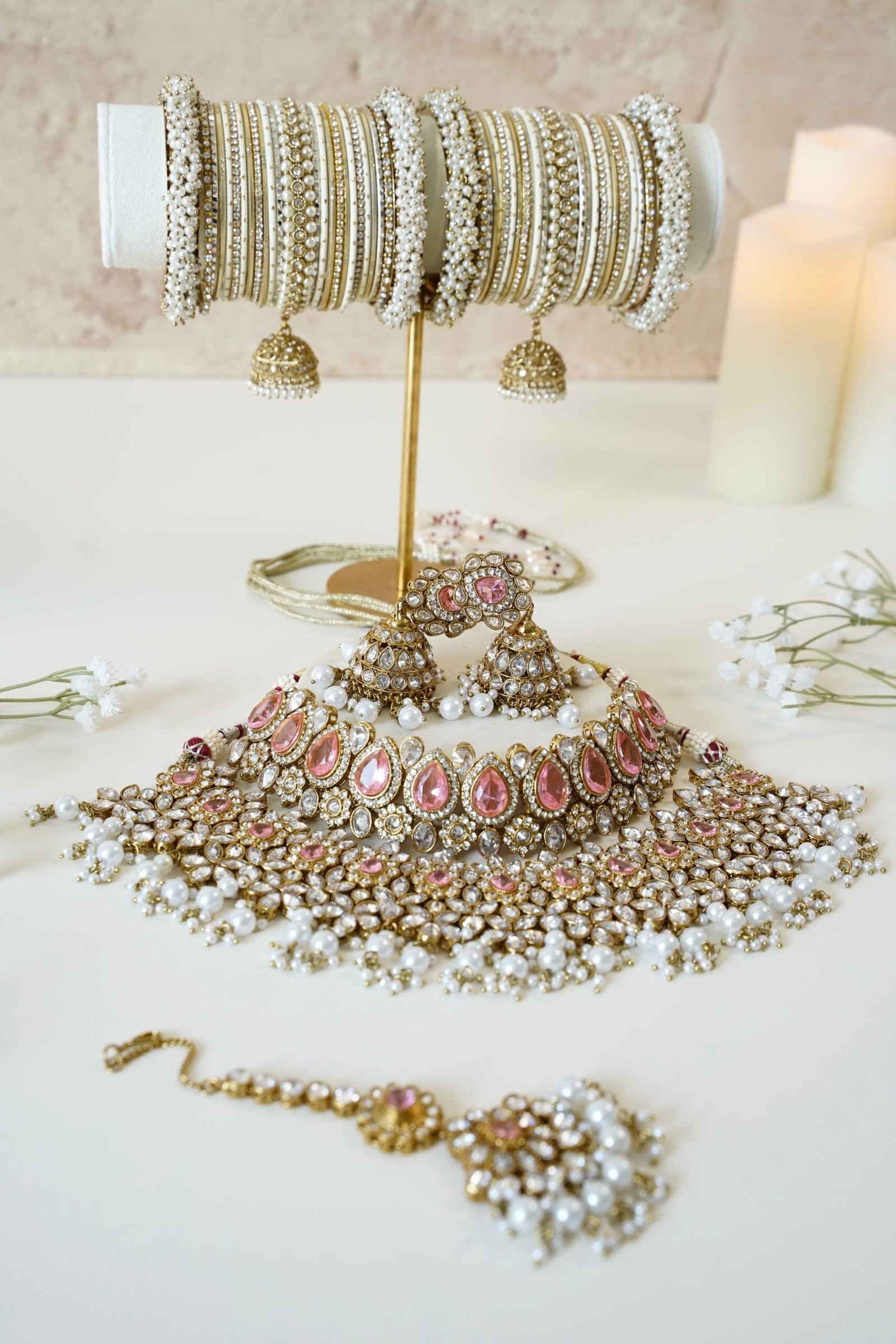 Two-layer bridal Indian Pakistani necklace set with pink stones featuring matching earrings and tikka, adjustable drawstring design for versatile styling