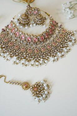 Two-layer bridal Indian Pakistani necklace set with pink stones featuring matching earrings and tikka, adjustable drawstring design for versatile styling