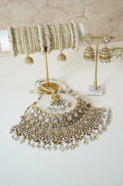 Two-layer Indian Pakistani bridal necklace set with clear stones and pearls featuring matching earrings and tikka, adjustable drawstring design for versatile styling