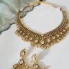 Kundan gold tone necklace set with matching earrings featuring tiny pearl drops and a royal traditional design