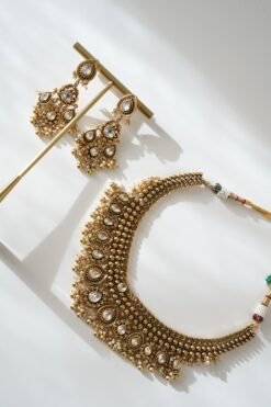 Kundan gold tone necklace set with matching earrings featuring tiny pearl drops and a royal traditional design