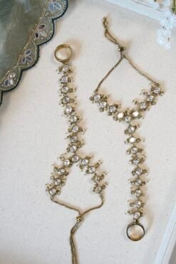 Indian haathphool hand harness with continuous kundan detailing extending from the wrist to the connected ring