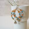 Multicolor jhumka hoop earrings with vibrant stones, perfect for mehendi night and festive occasions