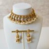 Gold tone mini multi jhumka necklace set with matching earrings, featuring delicate hanging jhumka drops for a traditional yet modern look
