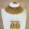 raditional gold finish kundan necklace set with matching earrings and maang tikka, featuring intricate detailing and a bold statement design