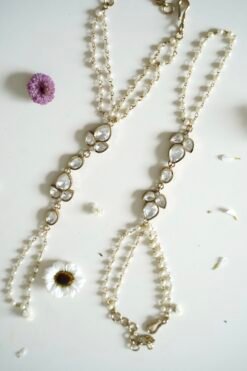 Delicate haathphool hand harness featuring kundan stones and tiny pearl detailing with fine chains