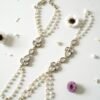 Delicate haathphool hand harness featuring kundan stones and tiny pearl detailing with fine chains