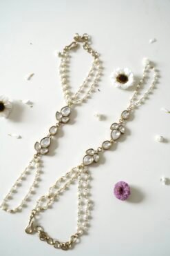 Delicate haathphool hand harness featuring kundan stones and tiny pearl detailing with fine chains
