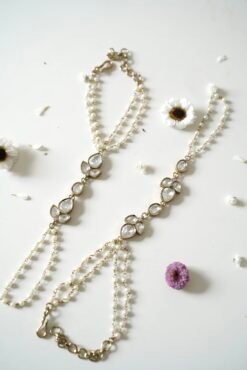 Delicate haathphool hand harness featuring kundan stones and tiny pearl detailing with fine chains