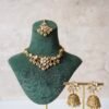 Small delicate floral kundan gold necklace set with jhumka earrings and matching tikka in traditional Indian design