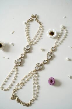 Delicate haathphool hand harness featuring kundan stones and tiny pearl detailing with fine chains