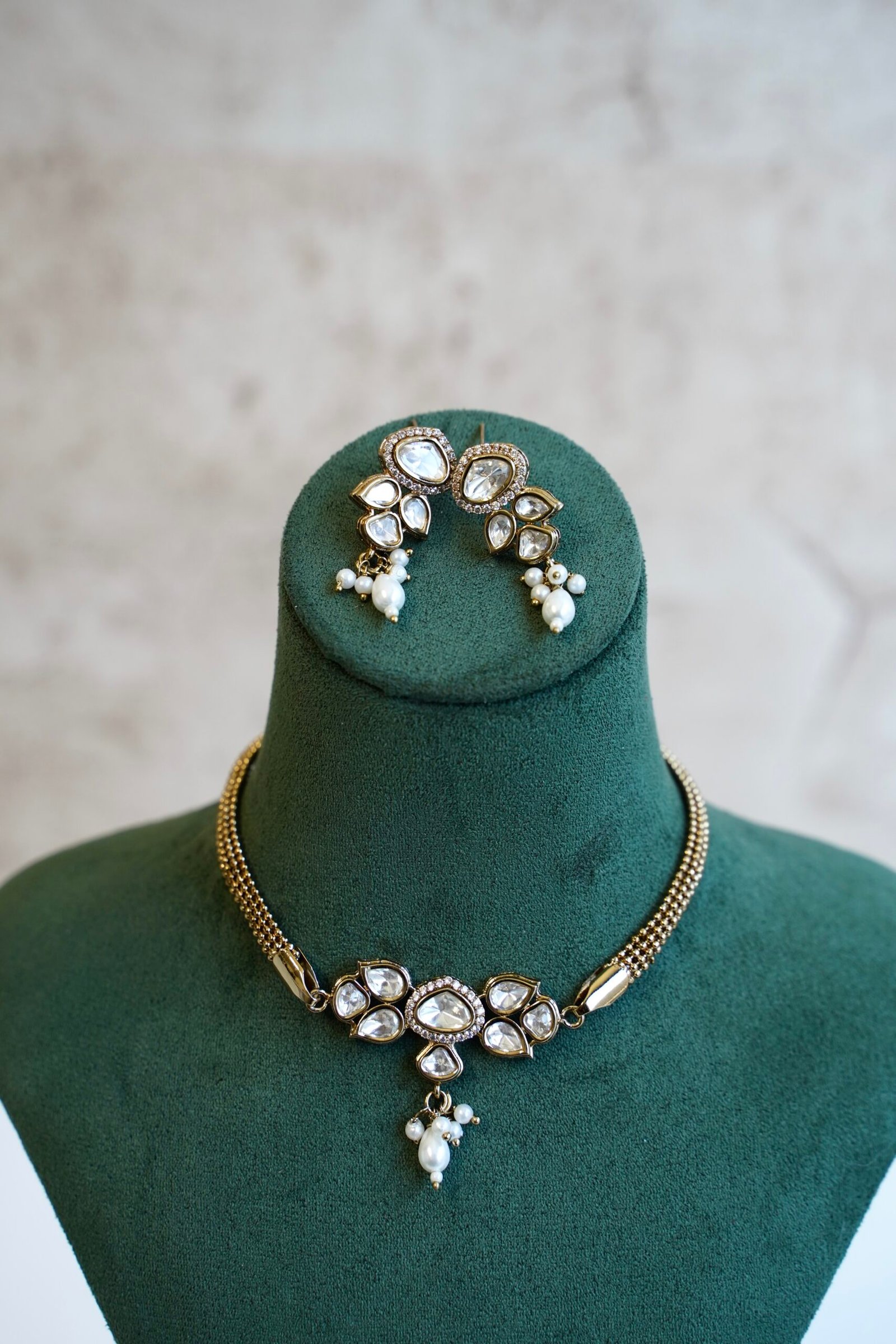 Dainty mini Kundan necklace with an adjustable chain and a pair of matching classic earrings by Seyora Jewels.