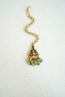 Traditional temple style tikka with elegant green bead accents for bridal, festive, and cultural wear.