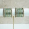 Blue metal bangle stack featuring statement kata bangles on each end, perfect for summer weddings and festive occasions.