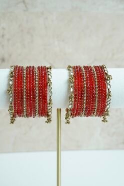 Red glass bangle stack with delicate ghungroo accent bangles for weddings, mehendi events, and festive wear.