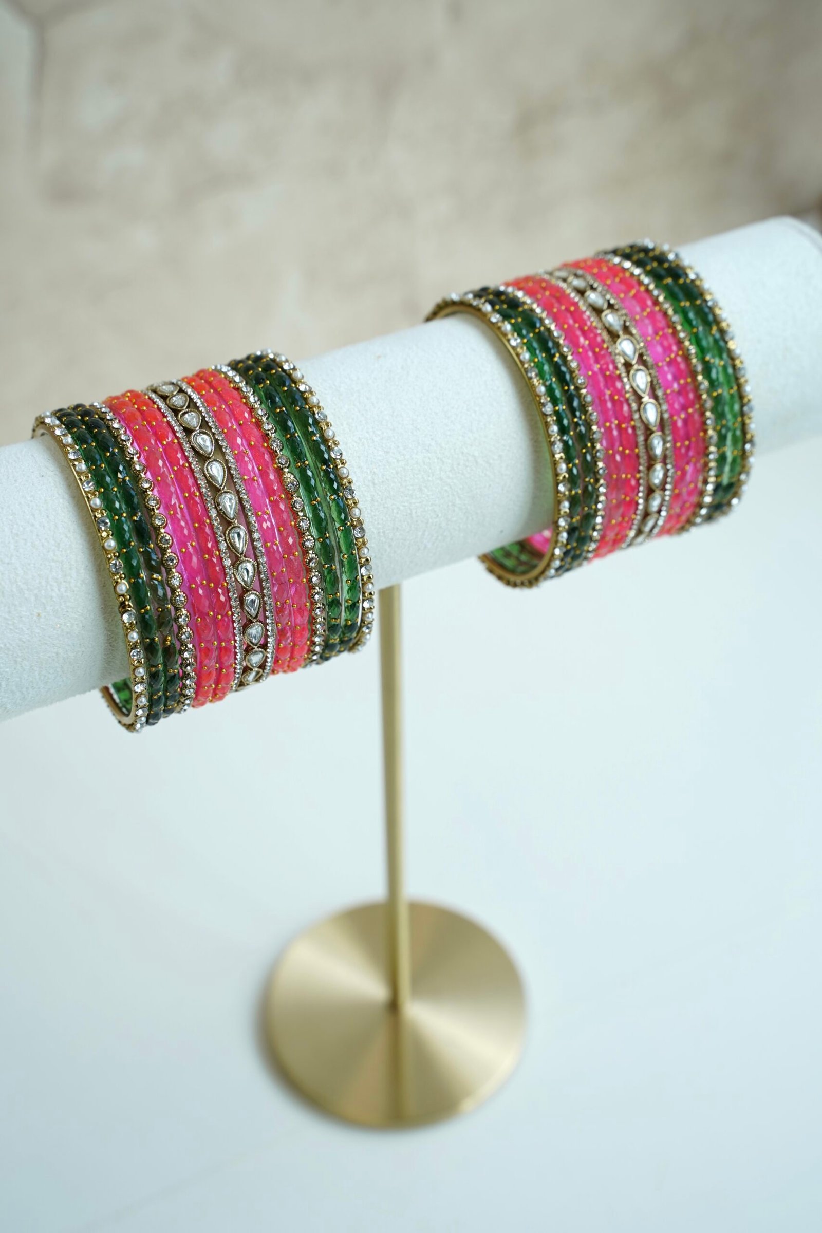 green and pink glass bangle stack with statement kundan centerpiece bangles for weddings and festive wear.