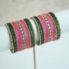 green and pink glass bangle stack with statement kundan centerpiece bangles for weddings and festive wear.