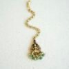 Traditional temple style tikka with elegant green bead accents for bridal, festive, and cultural wear.