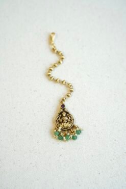 Traditional temple style tikka with elegant green bead accents for bridal, festive, and cultural wear.