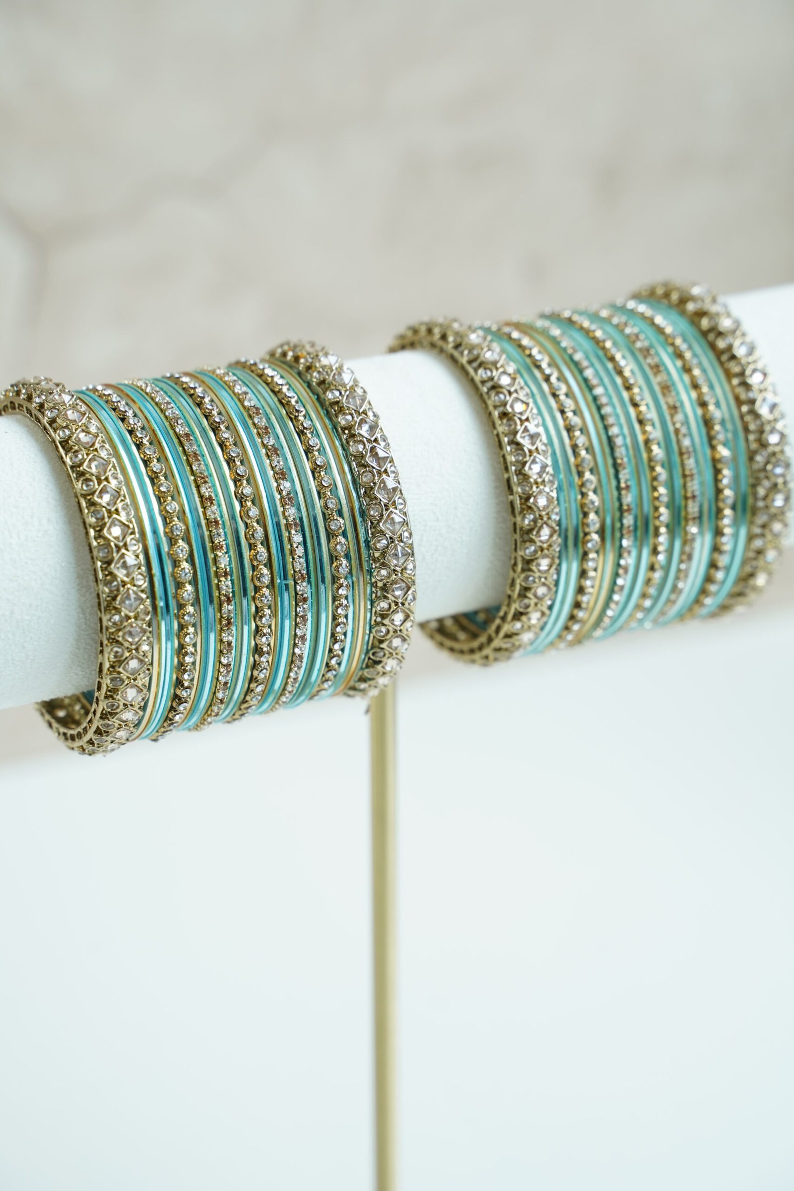 Blue metal bangle stack featuring statement kata bangles on each end, perfect for summer weddings and festive occasions.