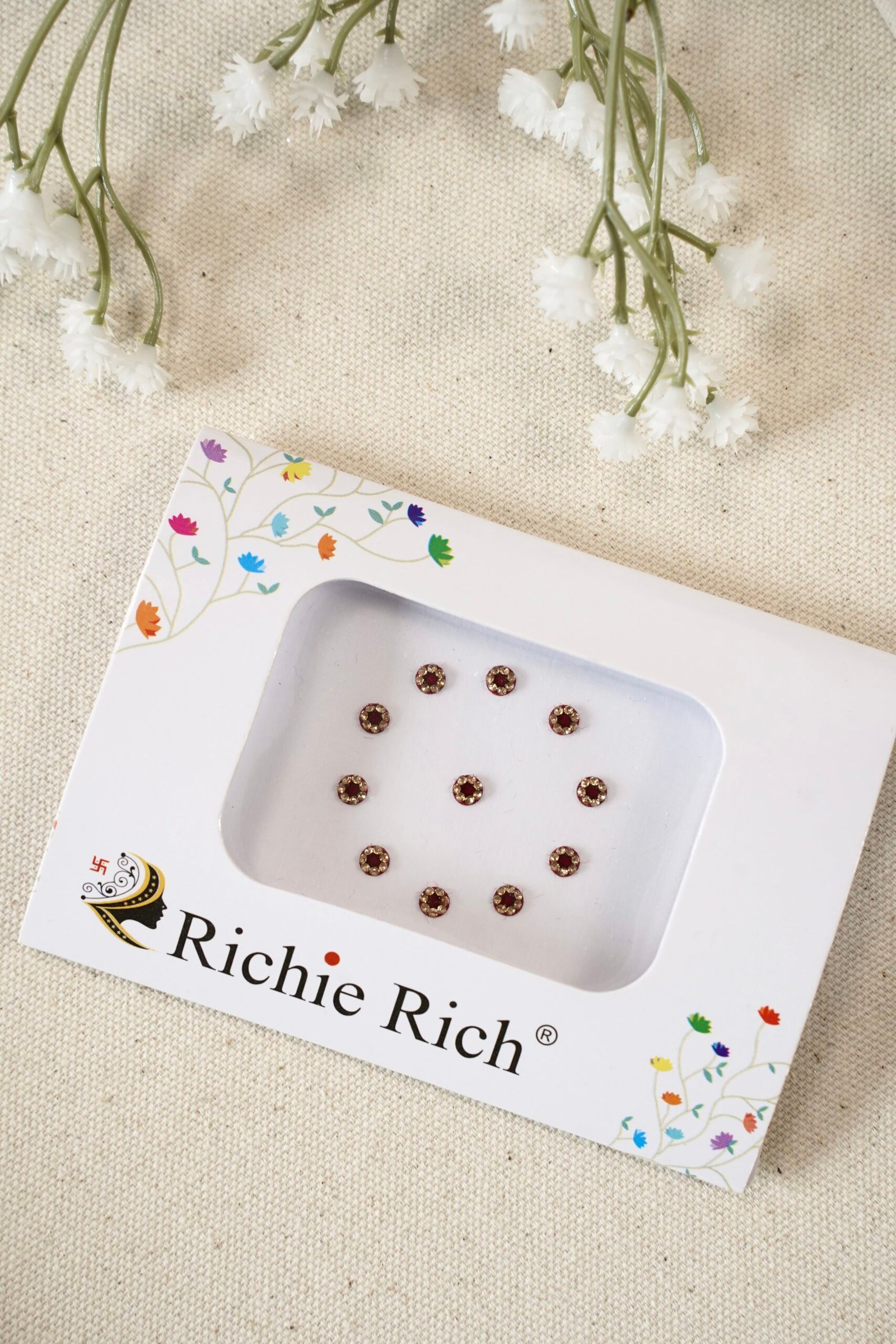 Maroon bindi with glittering crystal stone border and settings.