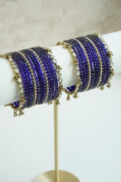 Blue glass bangle stack with delicate ghungroo accent bangles for weddings, mehendi events, and festive wear.