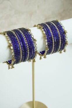 Blue glass bangle stack with delicate ghungroo accent bangles for weddings, mehendi events, and festive wear.
