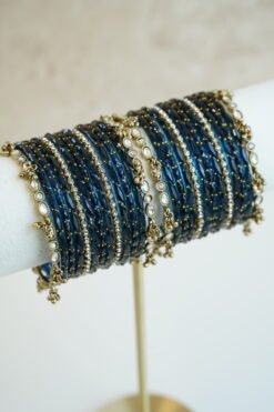 Blue glass bangle stack with delicate ghungroo accent bangles for weddings, mehendi events, and festive wear.