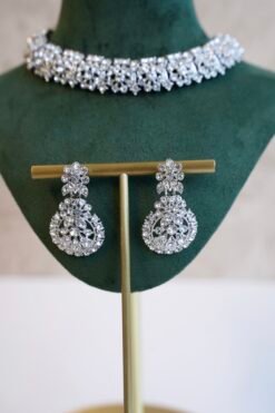 Delicate silver-plated petite stone necklace set with matching sparkly drop earrings and small pendant tikka.
