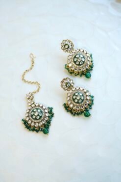 Green artificial Kundan choker necklace featuring a drop pendant and pearl beads, complete with matching earrings and tikka.