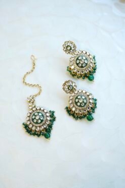 Green artificial Kundan choker necklace featuring a drop pendant and pearl beads, complete with matching earrings and tikka.