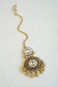 Traditional kundan tikka with elegant golden bead detailing for bridal, wedding, and festive wear.