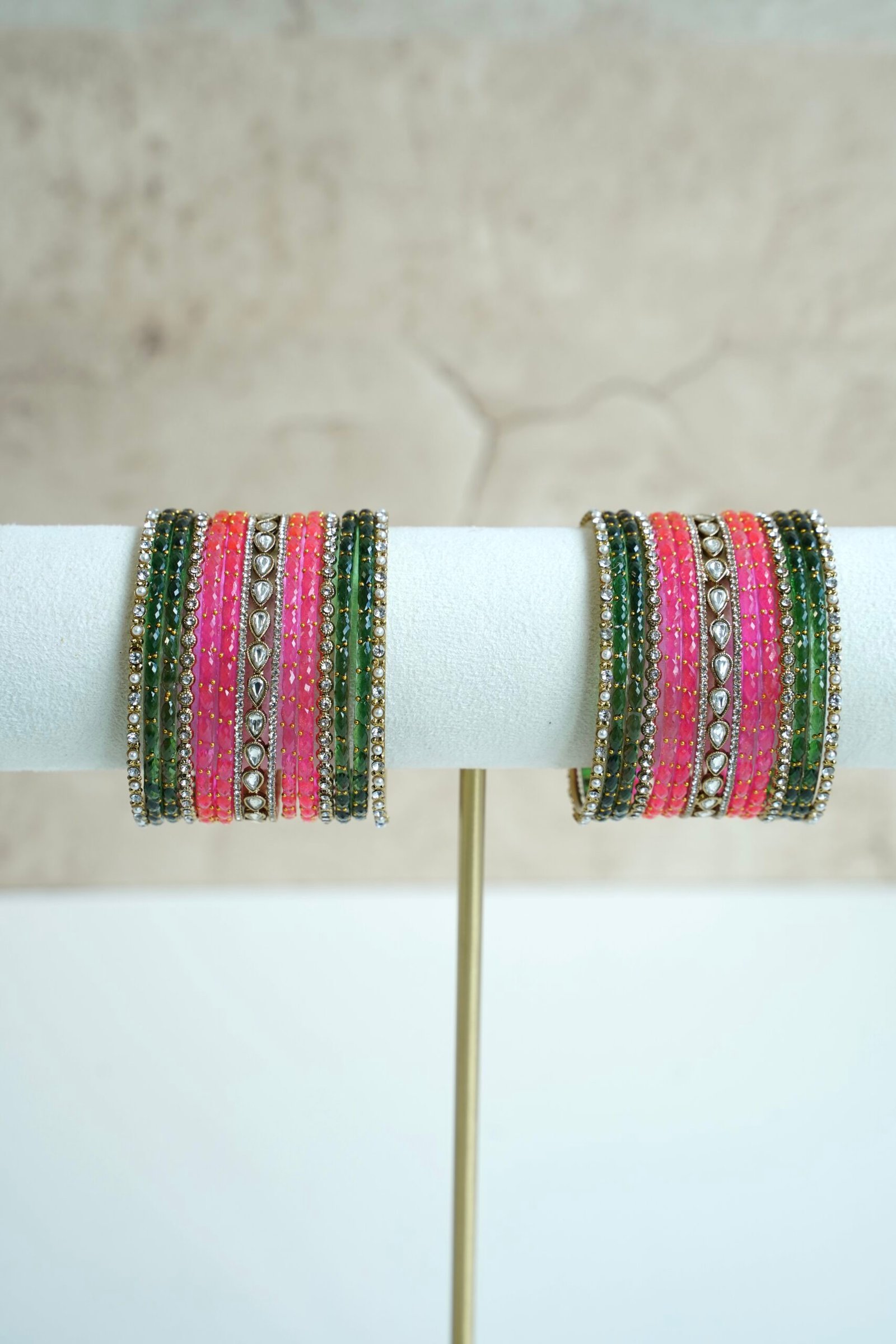 green and pink glass bangle stack with statement kundan centerpiece bangles for weddings and festive wear.