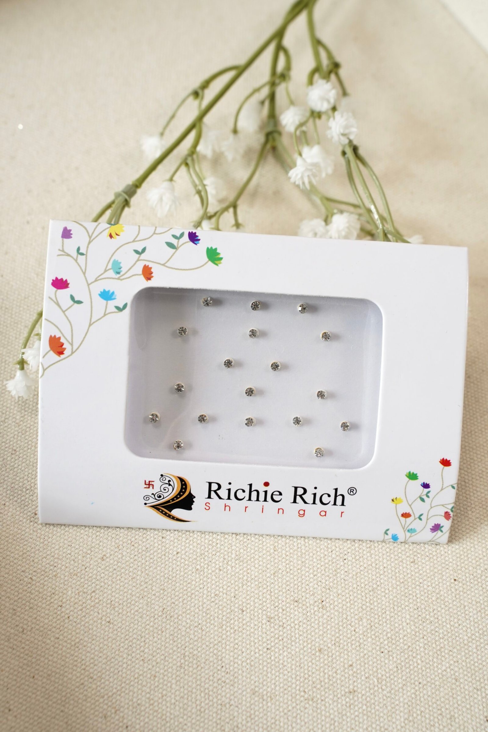 Pack of small silver bindis with glittering crystal stone settings.