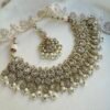 Seyora Jewels Tanya necklace set featuring champagne stones and delicately hanging pearl beads with matching jhumka earrings and maang tikka.