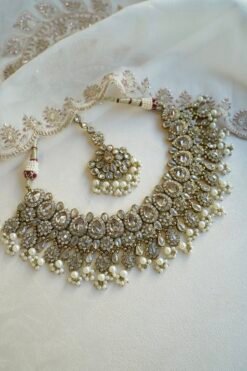 Seyora Jewels Tanya necklace set featuring champagne stones and delicately hanging pearl beads with matching jhumka earrings and maang tikka.