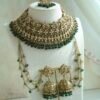 Seyora Jewels bridal jewelry set featuring a champagne stone necklace with emerald green beads, matching jhumka earrings with kanchain, maang tikka, and passa