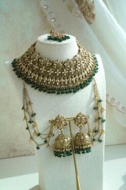 Seyora Jewels bridal jewelry set featuring a champagne stone necklace with emerald green beads, matching jhumka earrings with kanchain, maang tikka, and passa