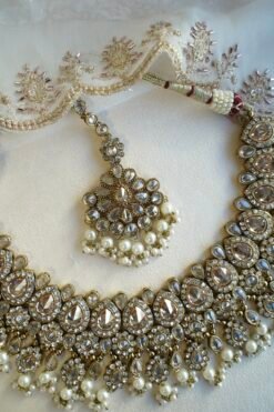 Seyora Jewels Tanya necklace set featuring champagne stones and delicately hanging pearl beads with matching jhumka earrings and maang tikka.