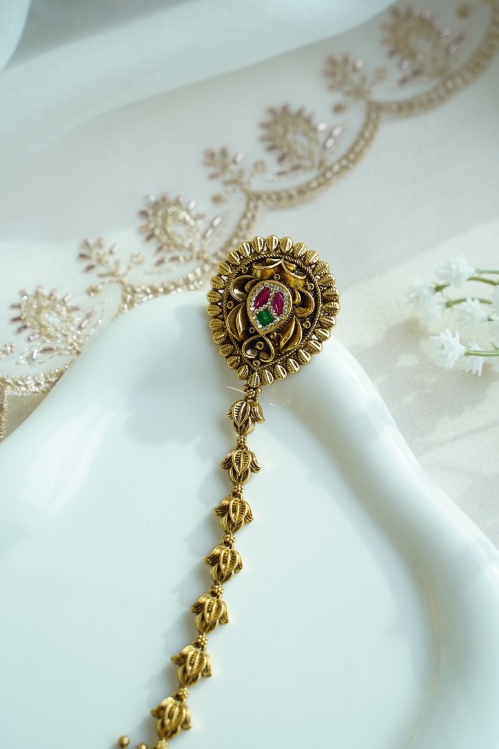Seyora Jewels gold-plated Kundan hathpan hand chain featuring an oval rani pink and green finger ring connected to an adjustable wrist chain.