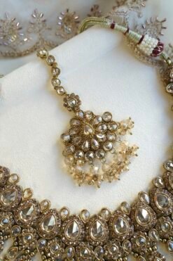 Seyora Jewels Tanya necklace set featuring champagne stones and hanging champagne crystal beads with matching jhumka earrings and maang tikka.